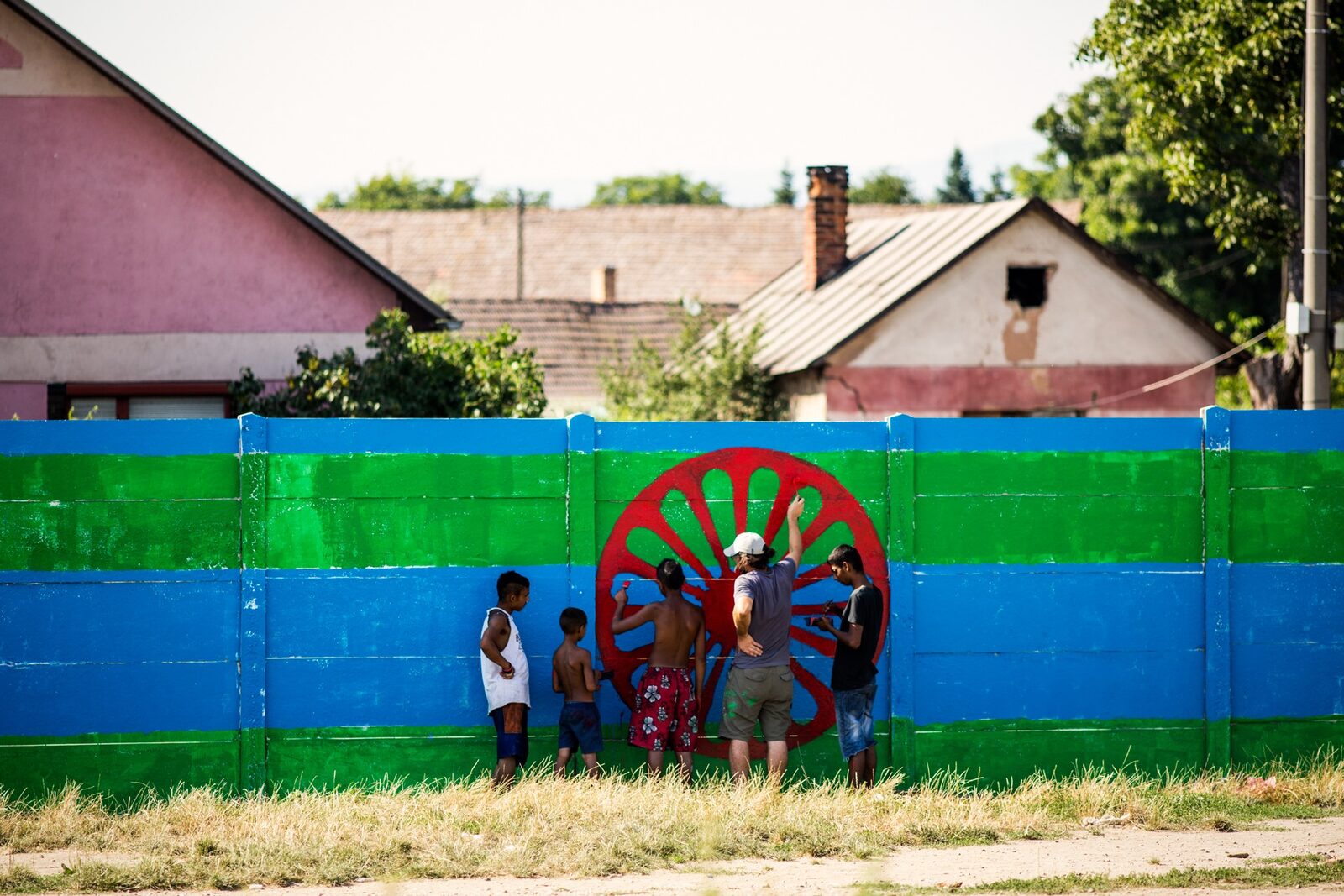 A street mural celebrating Roma rights, with children playing in front - photographed by ERGO Network.